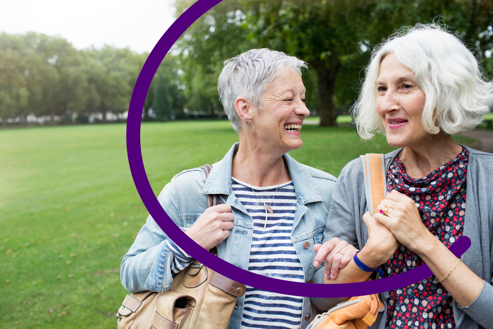 Two adults walking in the park talking